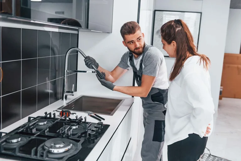 young-professional-plumber-in-grey-uniform-shows-r
